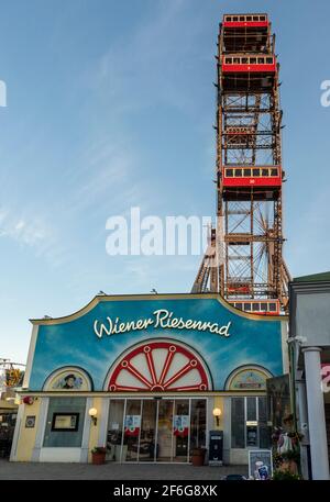 Entrance to the Prater Ferris Wheel: Riesenrad Wurstelprater: The entrance to Vienna's famous amusment park's most famous attraction a huge antique ferris wheel at sunset in a cloudless day. Stock Photo