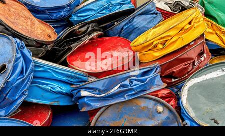 A pile of multicolored pressed metal barrels. Scrap metal for recycling Stock Photo