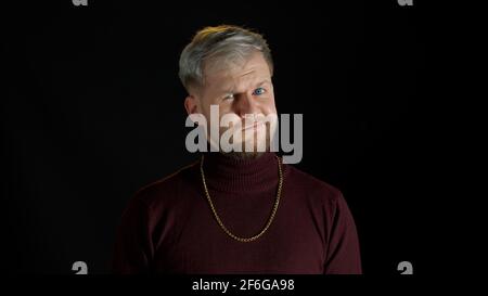 Unhappy depressed man, sorrow emotions, upset worried, bored, an irritated guy on black background Stock Photo