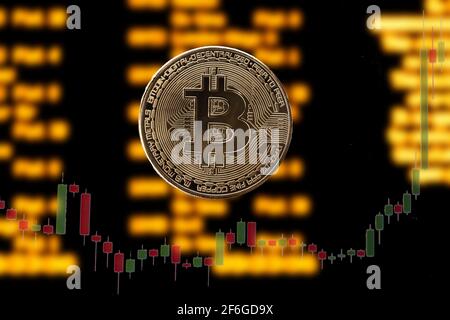 bitcoin on blur charts background Stock Photo