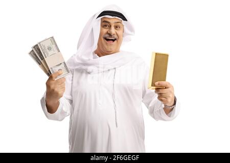 Mature arab man holding a gold ingot and money isolated on white background Stock Photo