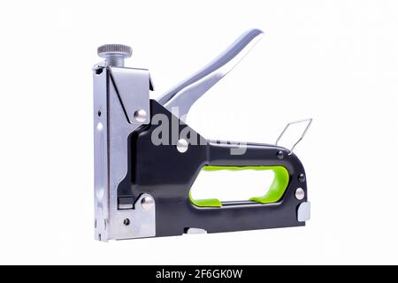 Upholstery stapler for furniture assembly. Tools for upholsterers used in the carpentry and upholstery shops. Light background. Stock Photo