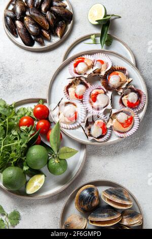 Seafood shellfish clams, mussels and scallops on gray plates Stock Photo