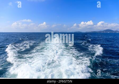 Boat wave ocean trace on blue sea fresh water background. Abstract sea water texture background. Travel destination motor boat water traces in open se Stock Photo