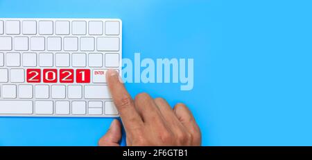 Finger hand man point ENTER on keyborad for new year 2021. Happy new year start up concept. With copy space. Stock Photo
