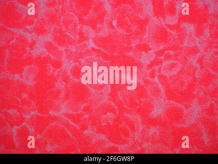 Bright red agate, a flat surface of natural stone with gray wavy veins. Background, pattern, texture. Stock Photo