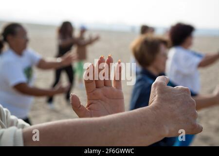 Group activity, Tai-chi-chuan class at Copacabana beach in the morning before work. Stock Photo