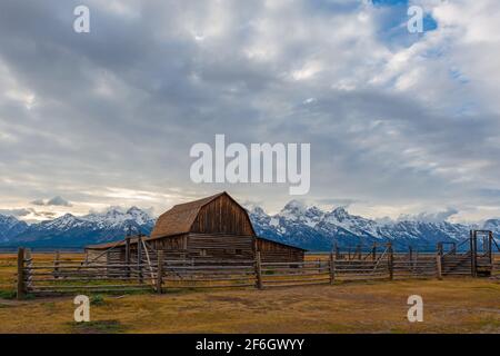 T. A. Moulton barn at sunset and Grand Teton range with snow in autumn, Grand Teton national park, Wyoming, United States of America (USA). Stock Photo