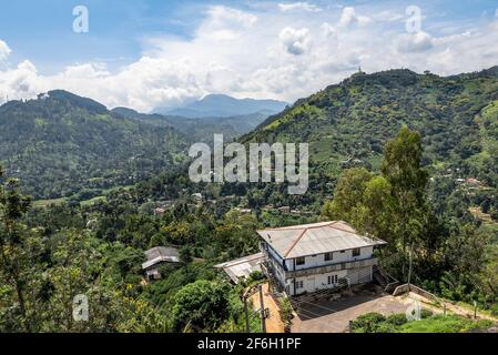 View of the mountain valley and houses among the forest and tea plantations on the island of Sri Lanka Stock Photo