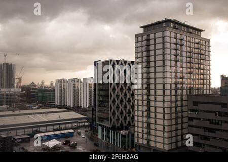 A View Across Salford Quays In Manchester On A Overcast Day Of Apartment And Office Buildings