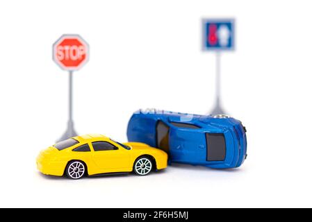 Accident with two toy cars and sign stop isolated on white. Concept picture about accident on the road Stock Photo