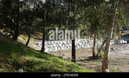 New white rock retaining wall for steep embankment in Andalusian countryside Stock Photo