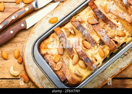 Dessert of toast bread,cottage cheese,banana and nuts.French breakfast on wooden table Stock Photo
