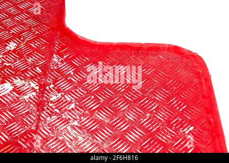 Close-up of an old red painted wavy metal floor with patterns against a white background Stock Photo