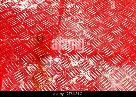Close-up of an old red painted metal floor with patterns and rusty stains Stock Photo