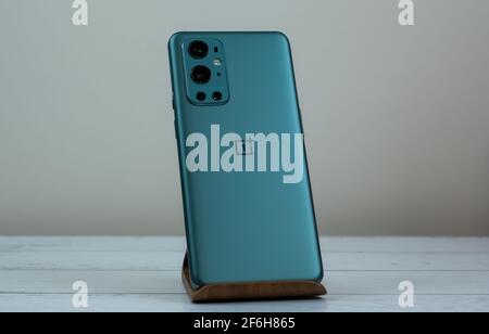 OnePlus 9 Pro 5G in Pine Green color. Stock Photo