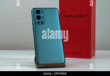 OnePlus 9 Pro 5G in Pine Green color. Stock Photo