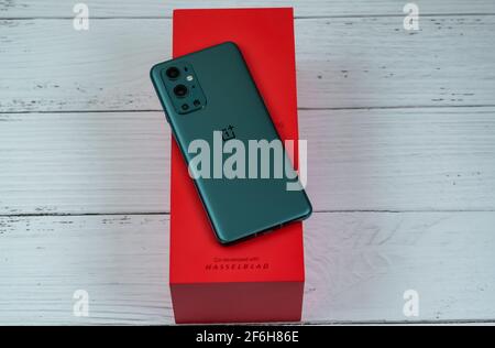 OnePlus 9 Pro 5G in Pine Green color. Stock Photo