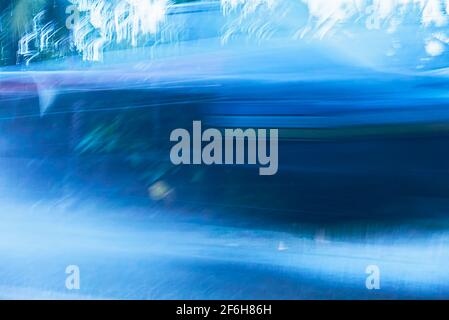 Cold blue colored blurry background with motion lines and white forms of ice crystals Stock Photo