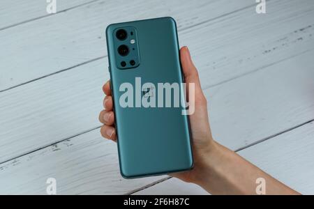 OnePlus 9 Pro 5G in Pine Green color. Stock Photo