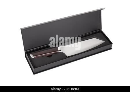 Meat cleaver from stainless steel with wooden handle lie in black box isolated on white background. Kitchen knife for chopping meat in black box. Stock Photo