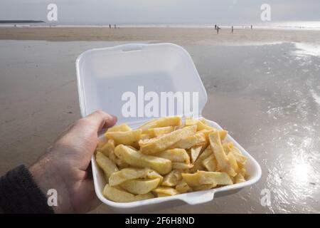 Portion,of,Fresh,hot,chips,in,polystrene,container,seaside,food,at,on,Aberavon Beach,Aberavon Sands,Port Talbot,Port Talbot Neath area,Council,Swansea Bay,South Wales,Wales,Welsh,GB,Britain,British,UK,United Kingdom,Europe, Stock Photo
