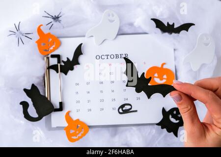 Calendar 31st of October date. Halloween background. Planning party. Flat lay. Top view. Halloween bat, pumpkin ghost decorations. Stock Photo