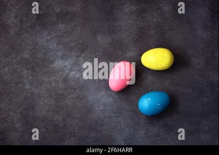 Directly above shot of colorful Easter eggs against black background Stock Photo