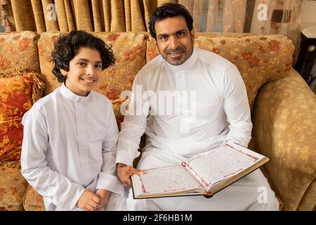 Arabic Language Father Arabian Father and Son reading Quran Holy Book Stock Photo - Alamy