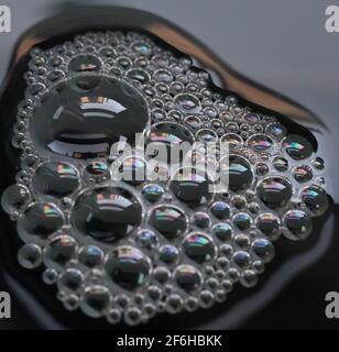A macro shot of a soap bubble in a washing up bowl close-up, bubbles within bubbles tightly packed together Stock Photo