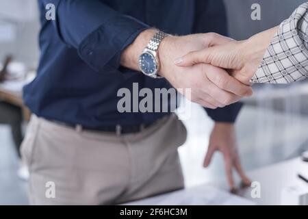 Close-up of businessman shaking hand to his partner he greeting him before meeting at office Stock Photo