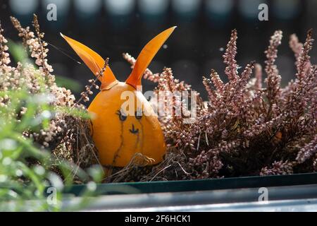 Crying easter egg bunny outside the window. Tears of joy. Stock Photo