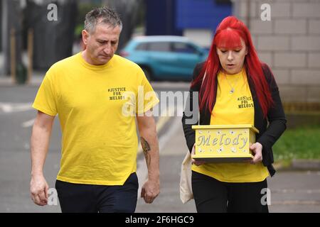 Nigel and Karina Driscoll, the parents of Melody Driscoll, arrive at Southwark Coroner's Court, south east London, carrying a box with her ashes in, during the inquest into her death. The Driscolls have alleged medics at King's College Hospital (KCH) reduced Melody's quality of life and contributed to her death, including improperly reducing her pain and steroid medications. Picture date: Thursday April 1, 2021. Stock Photo