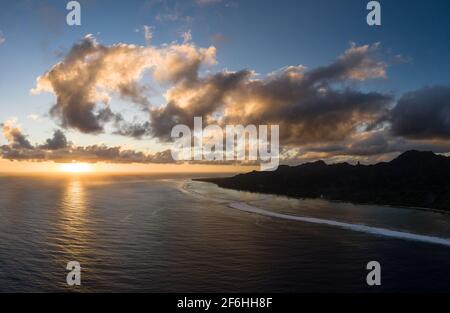 Dramatic aerial panorama of the sunset over the Rarotonga island, the main of the Cook islands archipelago in the south Pacific ocean. Stock Photo