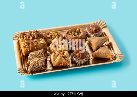 Assortment of Ramadan dessert baklava on blue background.  Traditional arabic sweets. Stock Photo
