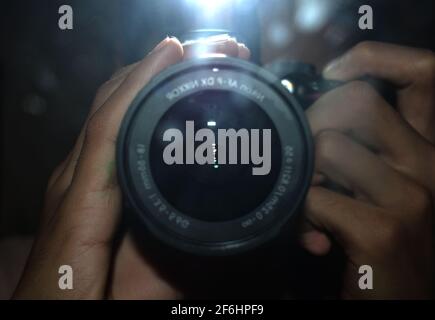 photo of a Nikon DSLR lens with the flash on creating glare. Stock Photo