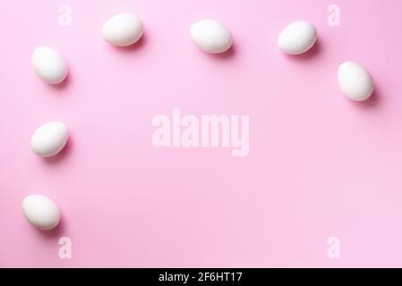 Food frame with white chicken eggs on pink background. Top view. Creative pattern in minimal style. Flat lay. Stock Photo