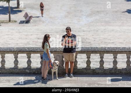 Lamego / Portugal - 07 25 2019 : View of young couple taking in the stairs of Lamego Cathedral with labrador guide dog Stock Photo