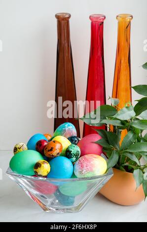 Easter eggs. Beautifully painted chicken and quail eggs in a crystal vase Stock Photo