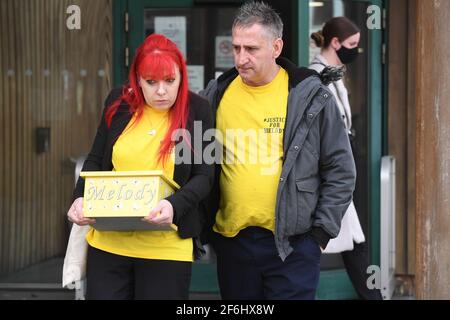 Nigel and Karina Driscoll, the parents of Melody Driscoll, leave Southwark Coroner's Court, London, carrying a box with their daughter's ashes in, following the inquest into her death. The seriously ill 11-year-old girl who had a 'complicated medical history' died after suffering complications following an operation for gallstones, a coroner has said. Picture date: Thursday April 1, 2021. Stock Photo