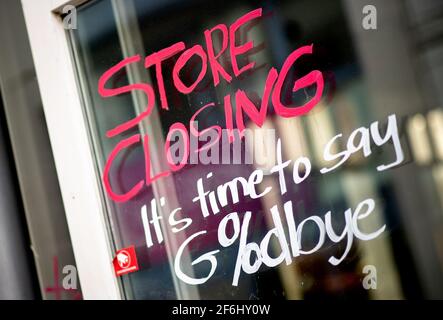 Oldenburg, Germany. 01st Apr, 2021. The English words 'Store Closing' and the addition 'It's time to say Goodbye' with a percent sign are written on the window of a closed store in the city center. In view of sharply rising Corona infection figures, the German government has extended the lockdown in Germany until April 18, 2021. Credit: Hauke-Christian Dittrich/dpa/Alamy Live News Stock Photo