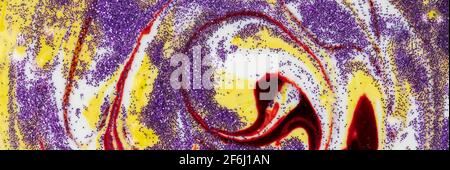 Yellow smeared in a circle with purple sparkles Abstract pattern with curls. Popular fashionable art design. Stock Photo