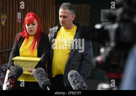 Nigel and Karina Driscoll, the parents of Melody Driscoll, hold a box containing her ashes as they talk to the media outside Southwark Coroner's Court, London, following the inquest into their daughter's death. The seriously ill 11-year-old girl who had a 'complicated medical history' died after suffering complications following an operation for gallstones, a coroner has said. Picture date: Thursday April 1, 2021. Stock Photo