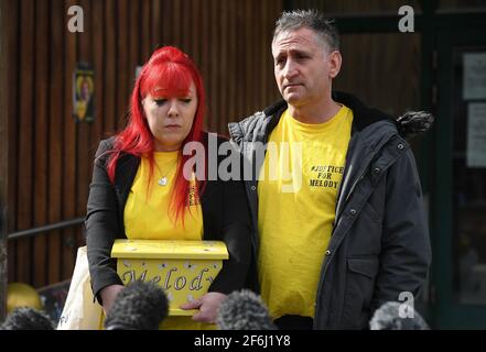 Nigel and Karina Driscoll, the parents of Melody Driscoll, hold a box containing her ashes as they talk to the media outside Southwark Coroner's Court, London, following the inquest into their daughter's death. The seriously ill 11-year-old girl who had a 'complicated medical history' died after suffering complications following an operation for gallstones, a coroner has said. Picture date: Thursday April 1, 2021. Stock Photo