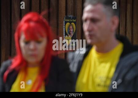 A photograph of Melody Driscoll attached to a wall outside Southwark Coroner's Court, London, as her parents Nigel and Karina Driscoll talk to the media following the inquest into their daughter's death. The seriously ill 11-year-old girl who had a 'complicated medical history' died after suffering complications following an operation for gallstones, a coroner has said. Picture date: Thursday April 1, 2021. Stock Photo