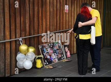 Nigel and Karina Driscoll, the parents of Melody Driscoll, look at tributes outside Southwark Coroner's Court, London, following the inquest into their daughter's death. The seriously ill 11-year-old girl who had a 'complicated medical history' died after suffering complications following an operation for gallstones, a coroner has said. Picture date: Thursday April 1, 2021. Stock Photo