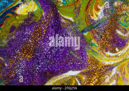 Multicolored acrylic backdrop sprinkled with purple sparkles. Contemporary creativity. Colorful avant-garde rich texture. A background made up of many Stock Photo