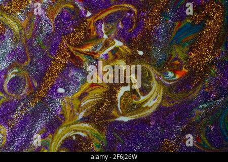 Multicolored acrylic background with curls sprinkled with purple and gold sparkles. Contemporary creativity. A colorful avant-garde painting with rich Stock Photo