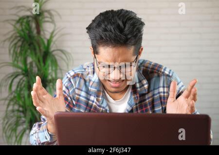 young stressed businessman working on laptop  Stock Photo