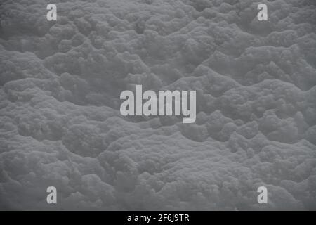 close up of freshly fallen snow on top of harder textured snow fluffy soft feeling white cloud like winter snow horizontal format room for type Stock Photo